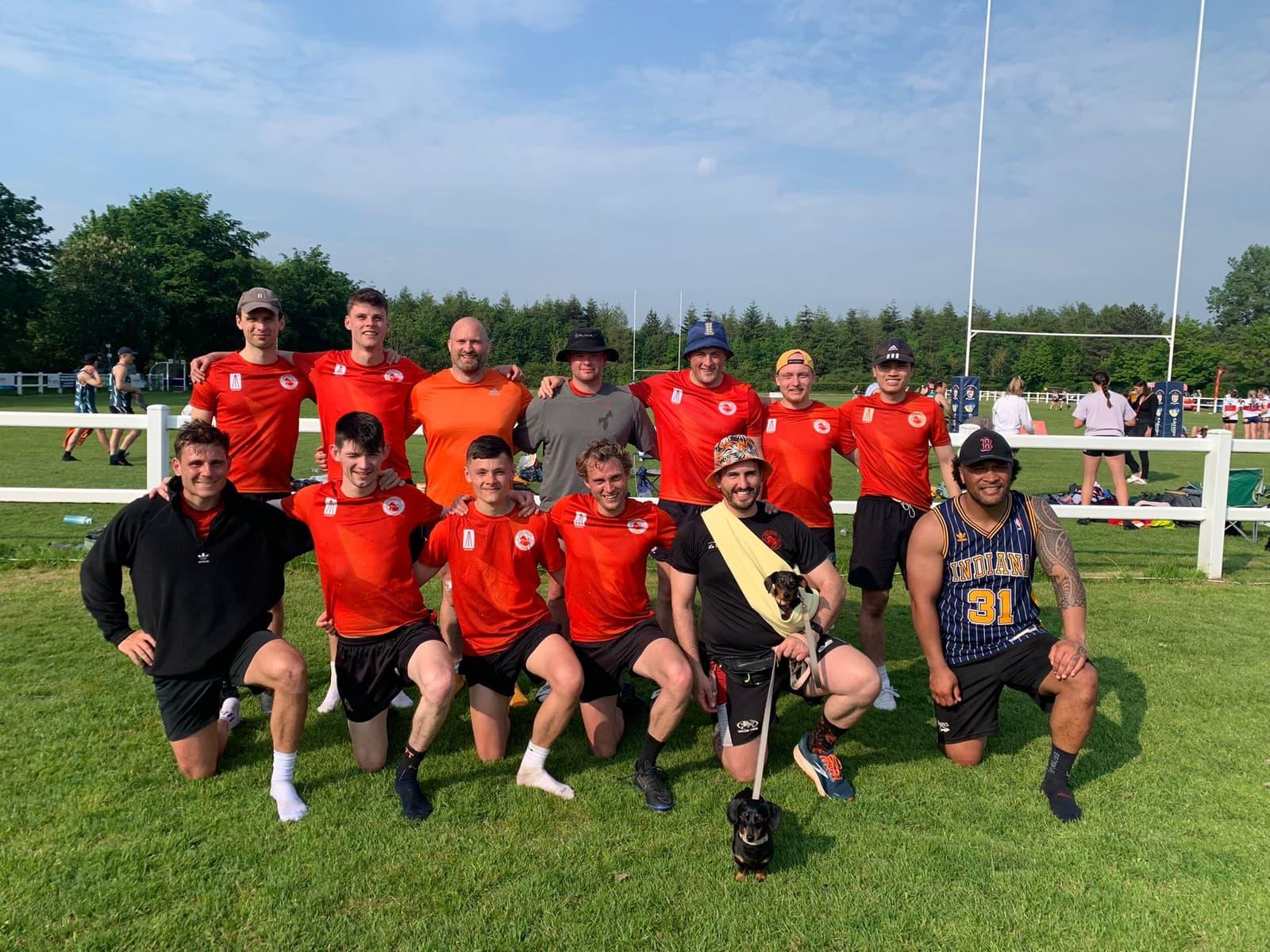 Manchester Foxes men's touch rugby squad at a UK tournament, posed in front of the posts