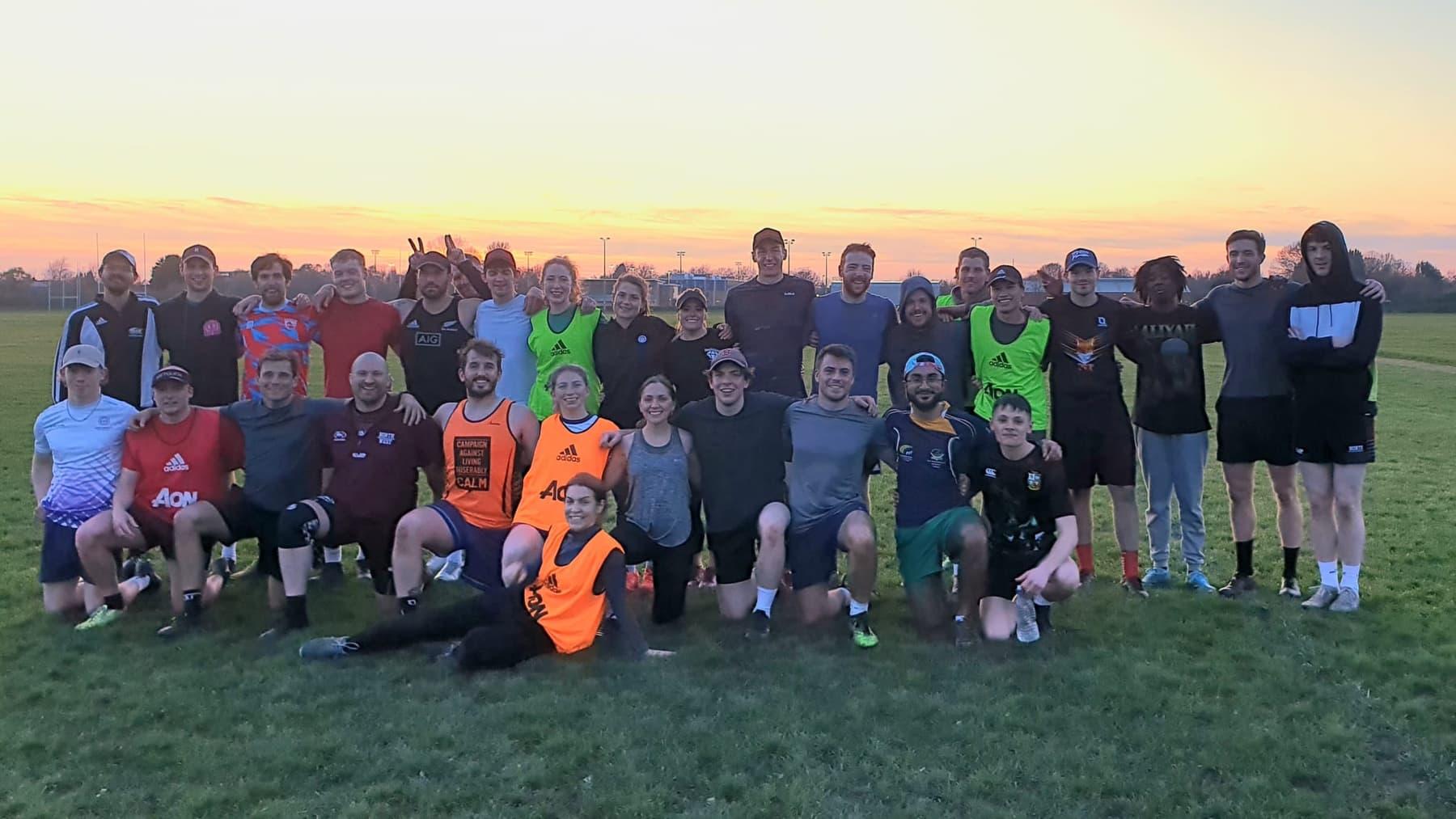 A full Monday night squad of Manchester Foxes players on the grass pitches at Hough End at sunset