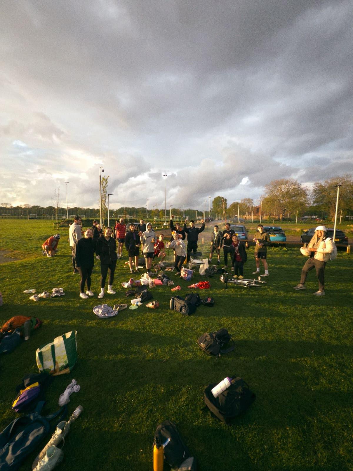 Manchester Foxes players and their kit bags spread across the pitch after a Monday evening session